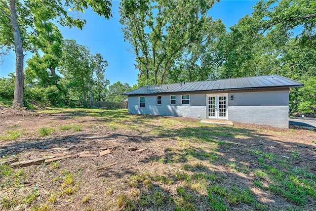 312 NW J St, Bentonville, AR 72712 - back of house featuring french doors, brick siding, and metal roof