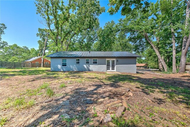 312 NW J St, Bentonville, AR 72712 - rear view of property with french doors, metal roof, and view of wooded area