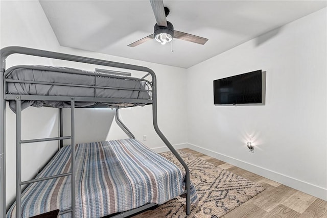 312 NW J St, Bentonville, AR 72712 - bedroom with wood finished floors, baseboards, and ceiling fan
