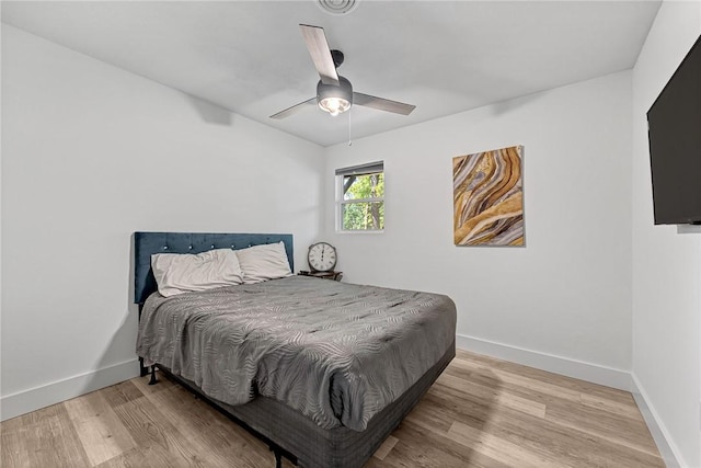 312 NW J St, Bentonville, AR 72712 - bedroom with light wood-style flooring, baseboards, and ceiling fan