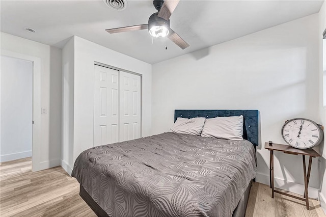 312 NW J St, Bentonville, AR 72712 - bedroom featuring wood finished floors, a closet, baseboards, and a ceiling fan