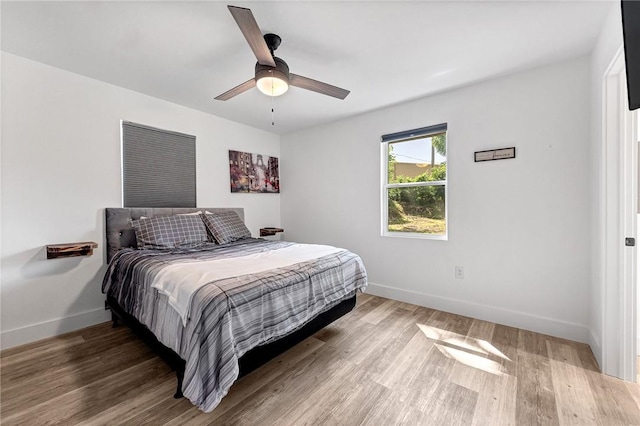 312 NW J St, Bentonville, AR 72712 - bedroom featuring baseboards, wood finished floors, and ceiling fan