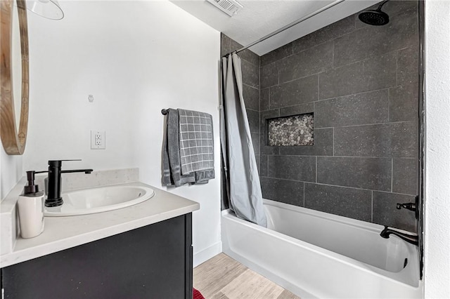 312 NW J St, Bentonville, AR 72712 - full bathroom featuring shower / tub combo with curtain, vanity, and wood finished floors