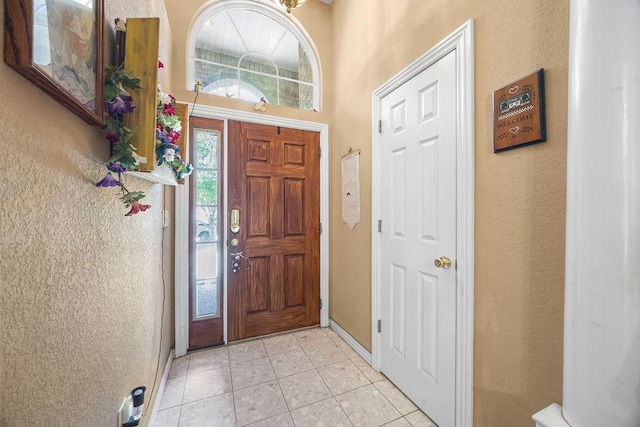 2977 Quartz Dr, Fayetteville, AR 72704 - entryway featuring light tile patterned flooring and a textured wall