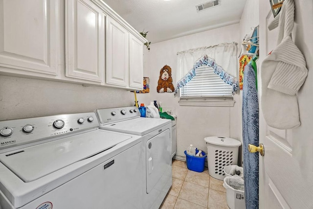 2977 Quartz Dr, Fayetteville, AR 72704 - washroom featuring washer and dryer, cabinet space, and light tile patterned flooring