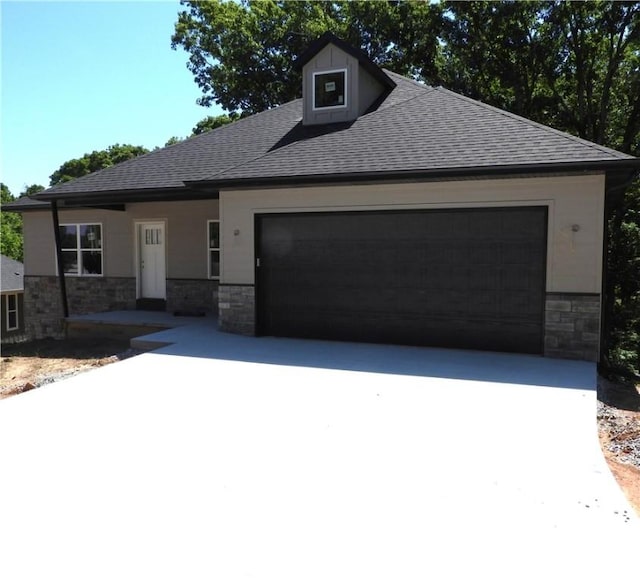 6 Marionet Cir, Bella Vista, AR 72714 - view of front of house with stone siding, a garage, a shingled roof, and driveway