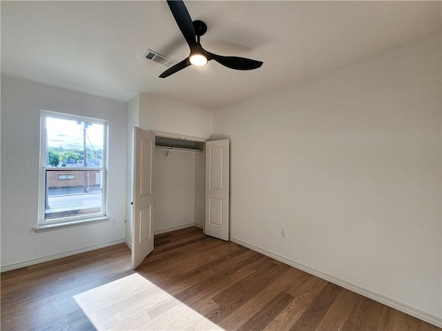1115 N Leverett Ave Unit 102, Fayetteville, AR 72703 - unfurnished bedroom featuring wood finished floors, baseboards, and a closet