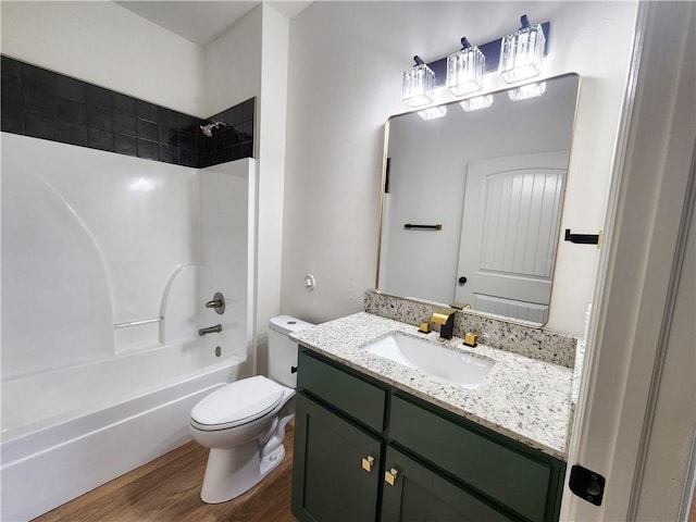 1115 N Leverett Ave Unit 102, Fayetteville, AR 72703 - full bathroom with vanity, toilet,  shower combination, and wood finished floors