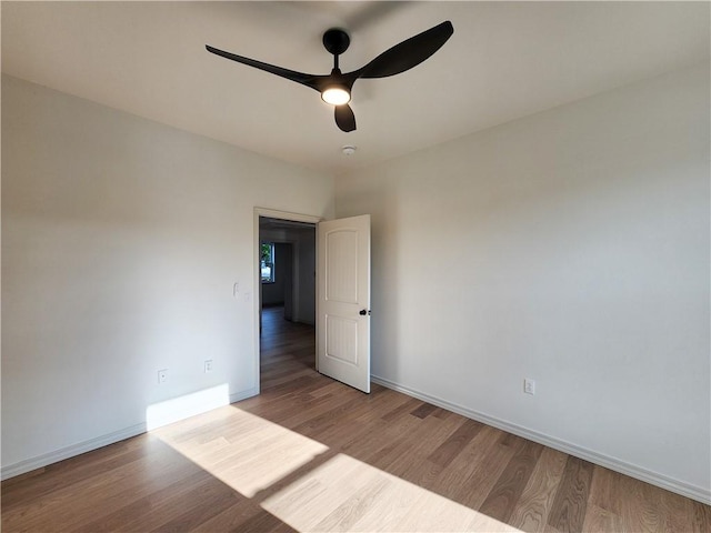 1115 N Leverett Ave Unit 102, Fayetteville, AR 72703 - unfurnished room with wood finished floors, baseboards, a ceiling fan, and a smoke detector