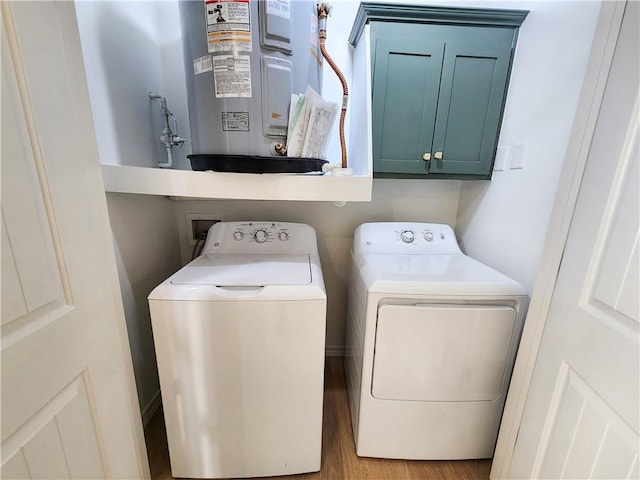 1115 N Leverett Ave Unit 102, Fayetteville, AR 72703 - laundry area with cabinet space, water heater, washing machine and clothes dryer, and wood finished floors