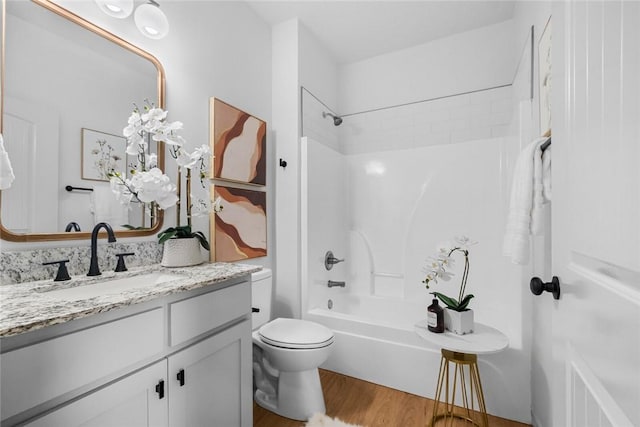 1115 N Leverett Ave Unit 102, Fayetteville, AR 72703 - full bath with vanity,  shower combination, toilet, and wood finished floors