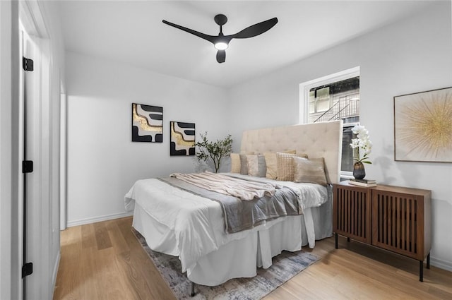 1115 N Leverett Ave Unit 102, Fayetteville, AR 72703 - bedroom featuring wood finished floors, ceiling fan, and baseboards