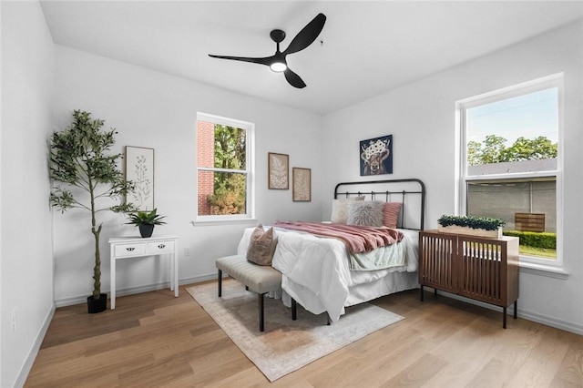 1115 N Leverett Ave Unit 102, Fayetteville, AR 72703 - bedroom with wood finished floors, baseboards, and a ceiling fan