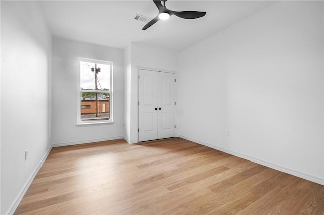 1115 N Leverett Ave Unit 102, Fayetteville, AR 72703 - unfurnished bedroom with light wood finished floors, baseboards, and a ceiling fan