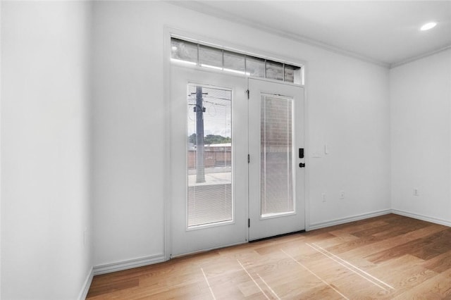 1115 N Leverett Ave Unit 102, Fayetteville, AR 72703 - entryway featuring ornamental molding, light wood-style floors, and baseboards