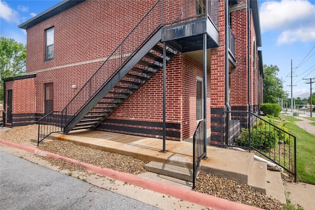 1115 N Leverett Ave Unit 102, Fayetteville, AR 72703 - view of home's exterior featuring brick siding and stairway
