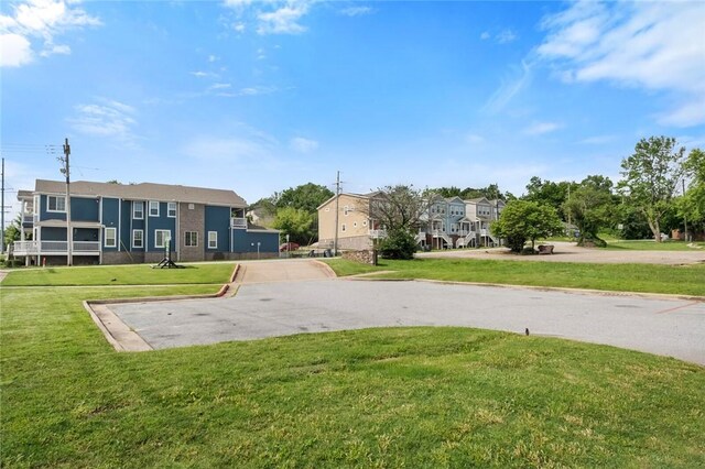 1115 N Leverett Ave Unit 102, Fayetteville, AR 72703 - view of front of house featuring driveway, a front lawn, and a residential view