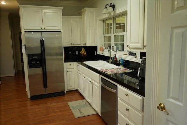 2655 S Elmira Ave, Russellville, AR 72802 - kitchen with stainless steel appliances, a sink, ornamental molding, white cabinetry, and dark wood-type flooring