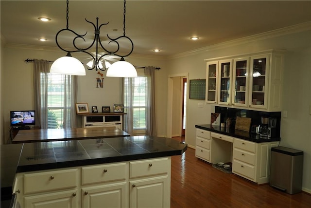 2655 S Elmira Ave, Russellville, AR 72802 - kitchen featuring dark countertops, dark wood-style flooring, ornamental molding, glass insert cabinets, and white cabinetry