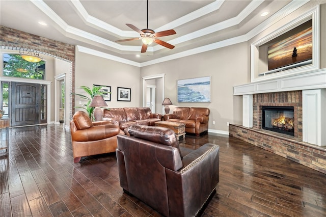 1651 Quail Ridge Way, Bentonville, AR 72713 - living area featuring baseboards, ornamental molding, a raised ceiling, dark wood-type flooring, and a ceiling fan