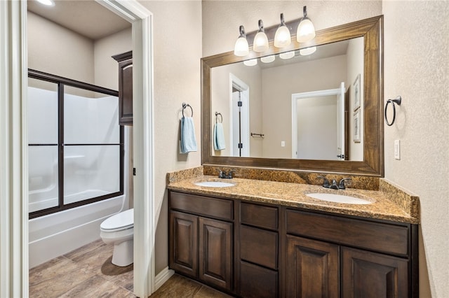 1651 Quail Ridge Way, Bentonville, AR 72713 - bathroom featuring toilet, double vanity, combined bath / shower with glass door, and a textured wall