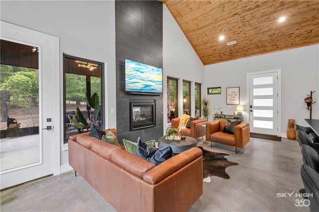 8775 Falls Hollow Rd, Rogers, AR 72756 - living area with concrete floors, high vaulted ceiling, healthy amount of natural light, wood ceiling, and a fireplace