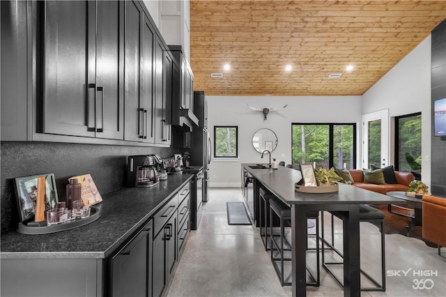 8775 Falls Hollow Rd, Rogers, AR 72756 - kitchen featuring electric range, a sink, dark countertops, wooden ceiling, and concrete flooring