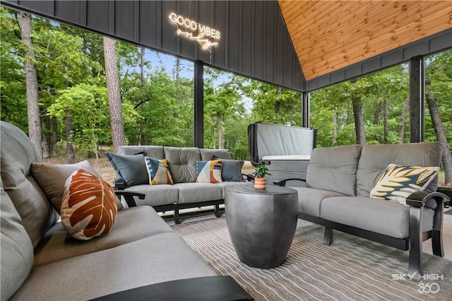 8775 Falls Hollow Rd, Rogers, AR 72756 - sunroom / solarium with an outdoor hangout area, lofted ceiling, and view of scattered trees