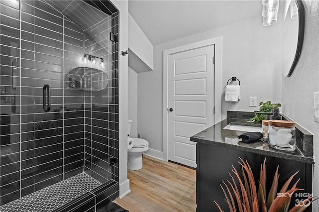 8775 Falls Hollow Rd, Rogers, AR 72756 - full bathroom with vanity, toilet, a stall shower, and wood finished floors
