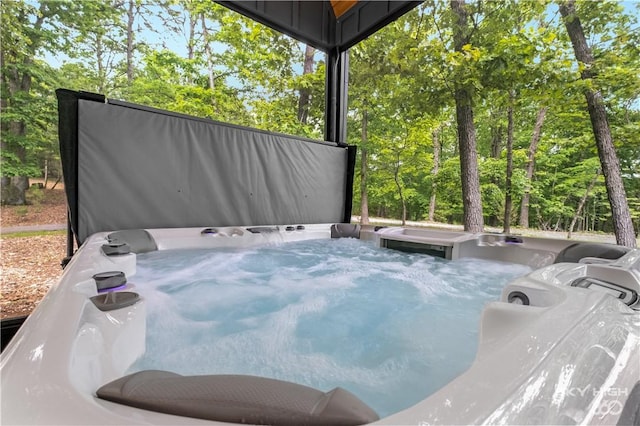8775 Falls Hollow Rd, Rogers, AR 72756 - view of patio / terrace featuring a hot tub and view of scattered trees
