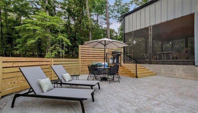 8775 Falls Hollow Rd, Rogers, AR 72756 - view of patio / terrace featuring stairs, a sunroom, outdoor dining space, and view of wooded area