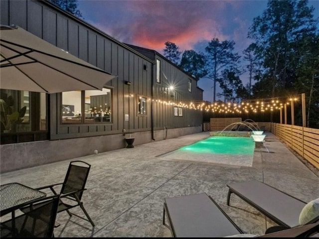 8775 Falls Hollow Rd, Rogers, AR 72756 - pool at dusk featuring a patio area and a fenced backyard