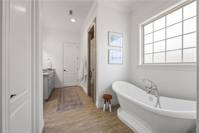 13 Dawn Hills Dr, Bentonville, AR 72712 - bathroom featuring vanity, crown molding, a stall shower, a freestanding tub, and baseboards