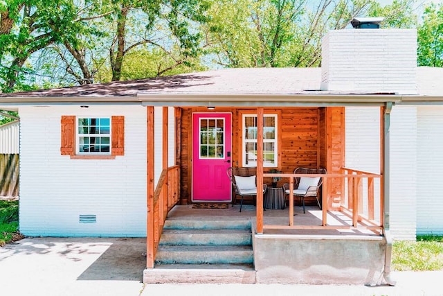 208 NW L St, Bentonville, AR 72712 - property entrance with a chimney, a porch, and a shingled roof