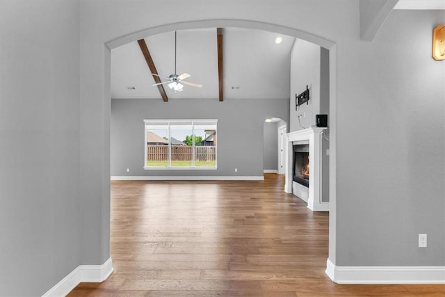 7326 Drury Ave, Springdale, AR 72762 - unfurnished living room featuring a ceiling fan, wood finished floors, a lit fireplace, and baseboards