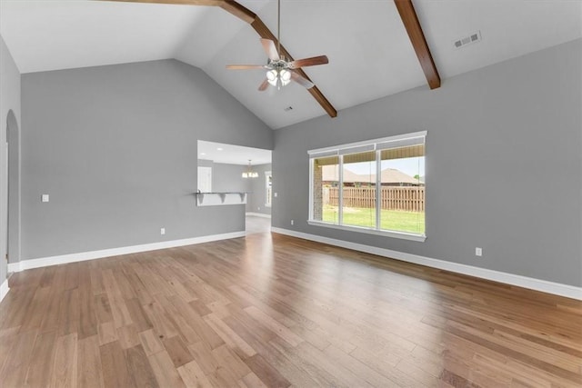 7326 Drury Ave, Springdale, AR 72762 - unfurnished living room with a ceiling fan, arched walkways, wood finished floors, high vaulted ceiling, and baseboards