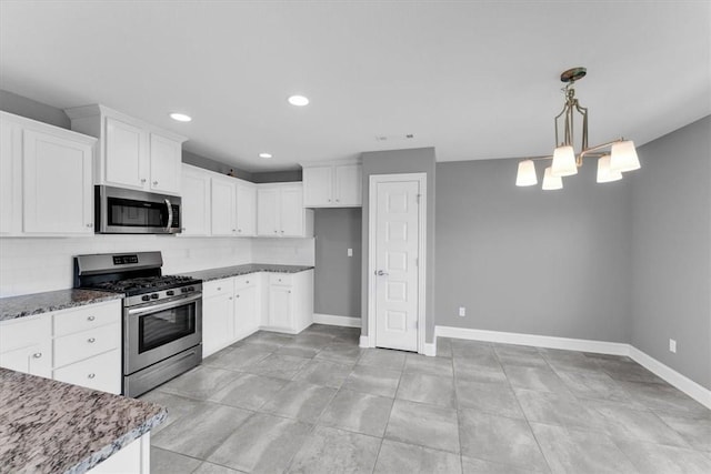 7326 Drury Ave, Springdale, AR 72762 - kitchen featuring stainless steel appliances, baseboards, decorative backsplash, dark stone counters, and white cabinets