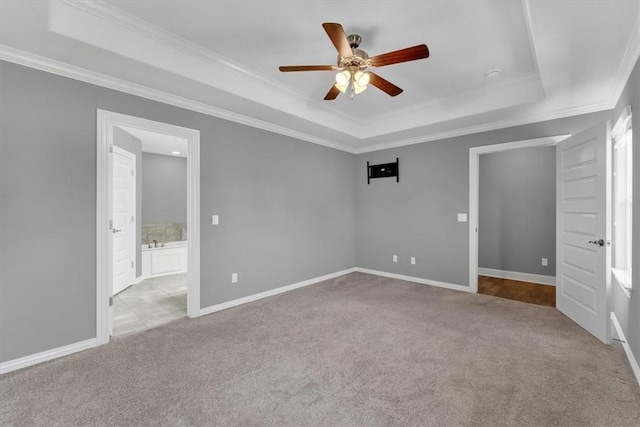 7326 Drury Ave, Springdale, AR 72762 - unfurnished bedroom with a tray ceiling, carpet, ornamental molding, ensuite bathroom, and baseboards