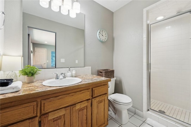 9193 Grimes Dr, Rogers, AR 72756 - full bathroom with a shower stall, vanity, toilet, and tile patterned floors