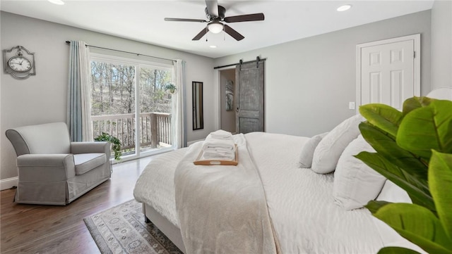 9193 Grimes Dr, Rogers, AR 72756 - bedroom featuring access to outside, a barn door, wood finished floors, baseboards, and recessed lighting