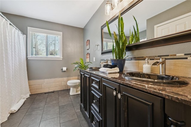 9193 Grimes Dr, Rogers, AR 72756 - bathroom with plenty of natural light, double vanity, toilet, and tile patterned flooring