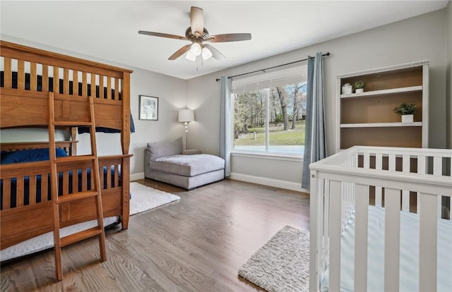 9193 Grimes Dr, Rogers, AR 72756 - bedroom featuring baseboards, wood finished floors, and a ceiling fan