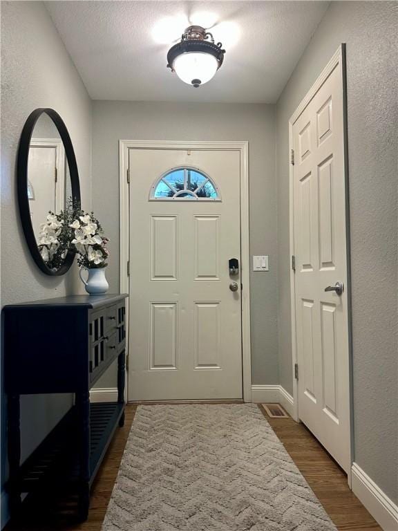 9193 Grimes Dr, Rogers, AR 72756 - foyer featuring dark wood finished floors and baseboards