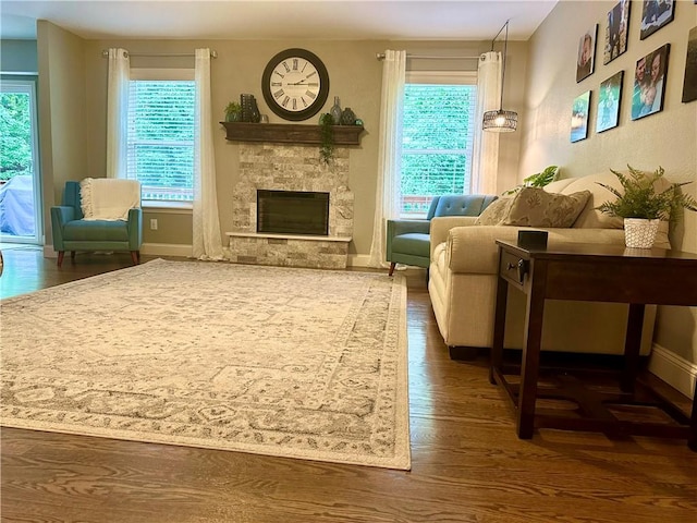 9193 Grimes Dr, Rogers, AR 72756 - living area with wood finished floors, a fireplace, and baseboards