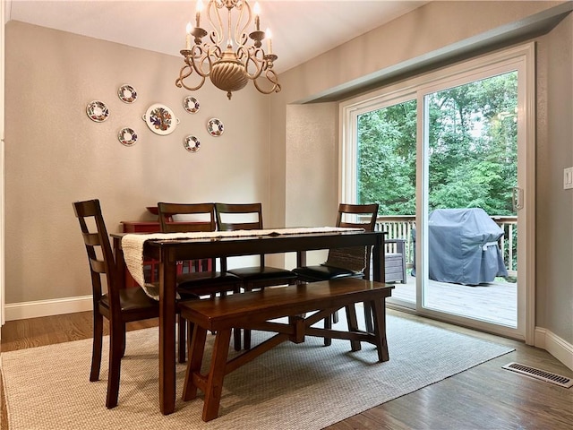 9193 Grimes Dr, Rogers, AR 72756 - dining area featuring a chandelier, baseboards, and light wood-style flooring