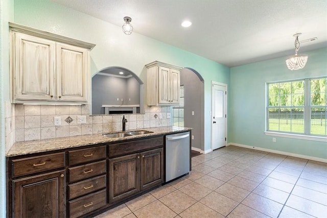 11029 Coleman Ct, Farmington, AR 72730 - kitchen featuring dishwasher, a sink, arched walkways, decorative backsplash, and dark brown cabinetry