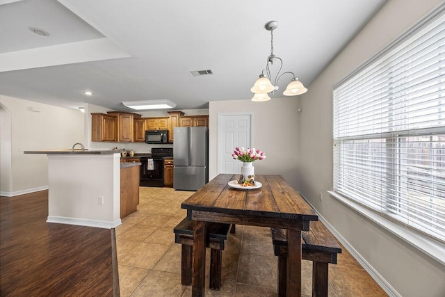340 Mckissic Spring Rd, Centerton, AR 72719 - dining area with a chandelier, arched walkways, and baseboards