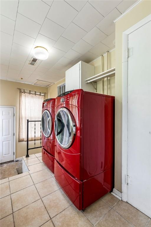 19574 Sonora Rd, Springdale, AR 72764 - laundry area with washing machine and clothes dryer and tile patterned flooring