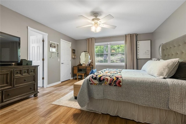 1525 Meadow Ct, Green Forest, AR 72638 - bedroom featuring light wood finished floors, a ceiling fan, and baseboards