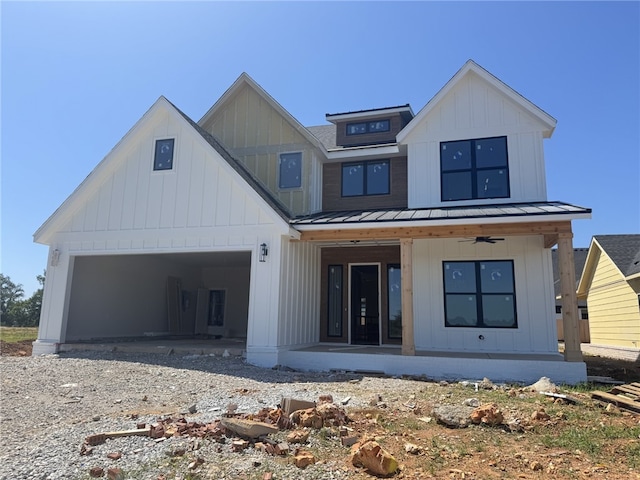 4108 Erin Dr, Rogers, AR 72758 - modern farmhouse style home with a porch, a standing seam roof, board and batten siding, metal roof, and an attached garage